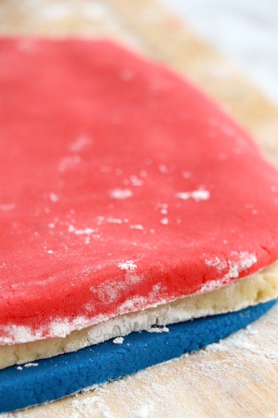 layering the colored dough to make the Patriotic Pinwheel Cookies recipe