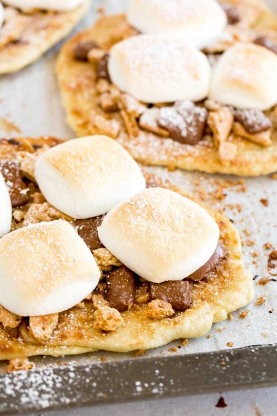 S’mores Flatbread slathered with cinnamon-sugar flavored butter and topped with crumbled graham crackers, ooey gooey chocolate and marshmallows.