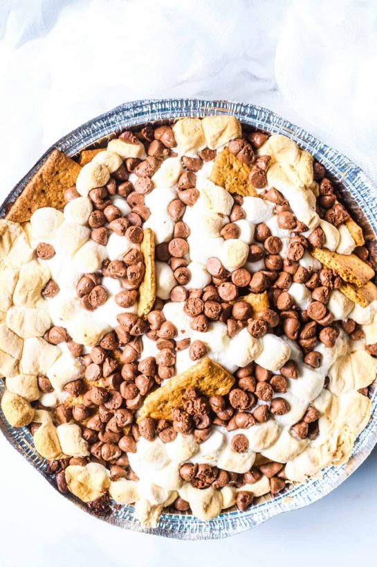 Toasty marshmallow, sweet, melty chocolate and crunchy graham crackers – S’mores are the flavor of summer. Now you can enjoy them anytime with this fun S’mores Nachos recipe that is perfect for cooking on the grill or in the oven.