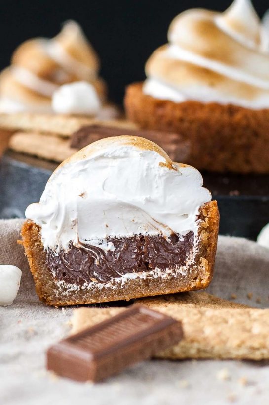 No campfire needed for these S’mores Cookie Cups! Graham cracker cookie cups filled with a Hershey’s milk chocolate ganache, topped with toasted homemade marshmallow fluff.