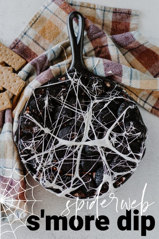 Spiderweb S'mores Dip recipe needs only a few ingredients, takes minutes to make, and is a super-fun Halloween party food idea! Creamy melted white chocolate topped with toasted marshmallows served with graham crackers, cookies, or fruit for dipping.