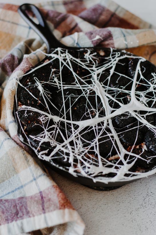 Creepy Spiderweb S'mores Dip recipe needs only a few ingredients, takes minutes to make, and is a super-fun Halloween party food idea! Creamy melted white chocolate topped with toasted marshmallows served with graham crackers, cookies, pretzels or fruit for dipping.