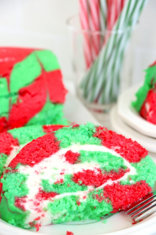 This Christmas Cake Roll is the perfect Holiday Dessert recipe for your friends and family! This cake is easy to make for the holidays and a fun twist on traditional cake, with the colors and look of Christmas!