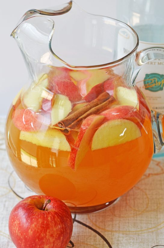 Pumpkin Sangria for a Crowd is a sweet, spiced, and full of fall flavors for the holiday season! This Pumpkin Sangria is perfect for autumn, Halloween pumpkin carving nights, Thanksgiving, or fall party!