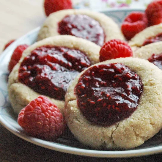 Peanut Butter and Jelly Thumbprints recipe. This recipe brings a lunchtime staple to a favorite cookie! What a wonderful combination!