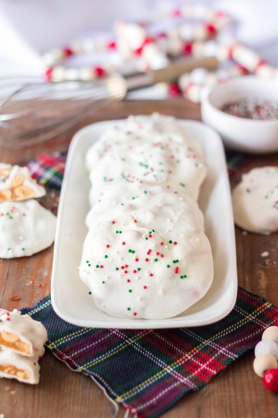 No-Bake Polar Bear Claws are a delicious holiday dessert and classic candy recipe for Christmas! The luscious caramel and salty roasted peanuts are coated in a silky white chocolate coating. I top them with sprinkles for a festive touch. 