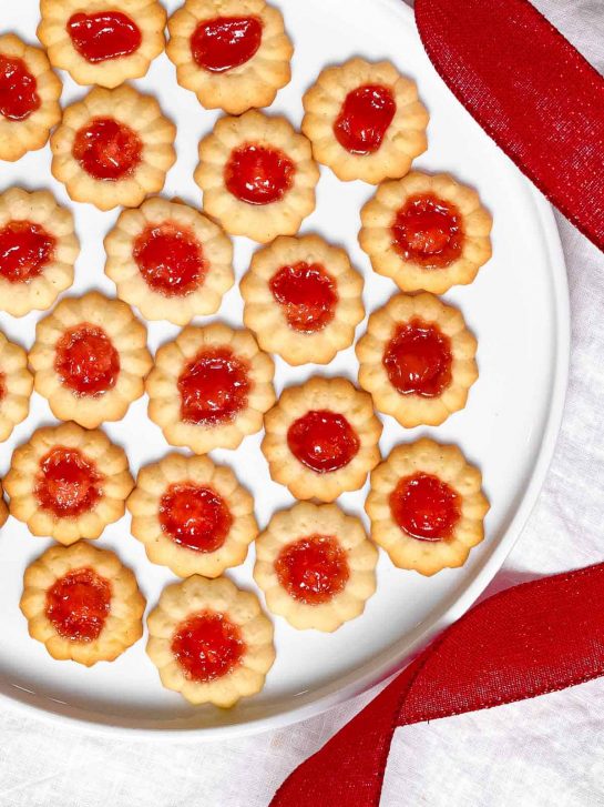 Spritz Cookies with Jam recipe. Add your favorite jam to these spritz cookies for thumbprint cookies you are sure to love.