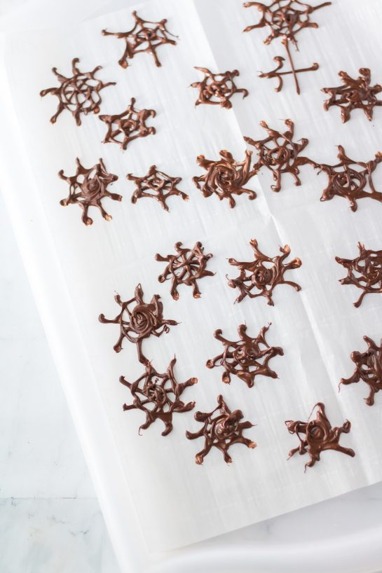 Making the chocolate spiderwebs for the Halloween Jello Shots recipe.