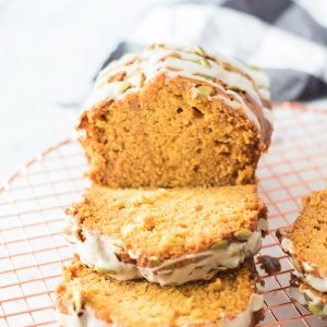 Maple-Glazed Pumpkin Bread is an easy holiday recipe teaching you how to make a moist, fresh pumpkin bread from scratch. This bread is drizzled with a simple maple glaze and each slice of this bread is so delicious for fall.