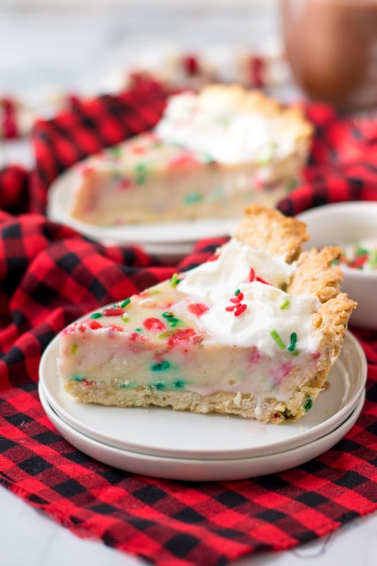 This Christmas Sugar Cream Pie recipe is my favorite for the holidays. This is a delicious creamy pie decorated with holiday jimmies sprinkles for a festive look. The filling is silky and rich - perfect for any occasion. The crust is a no-roll pie crust which makes it fabulous to throw together for the busy holiday season. 