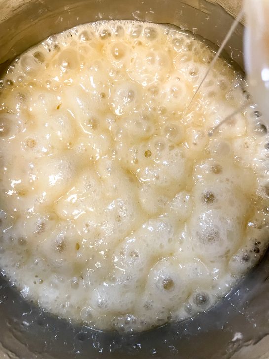 Boiling the ingredients to make New Year Champagne Popcorn Balls recipe