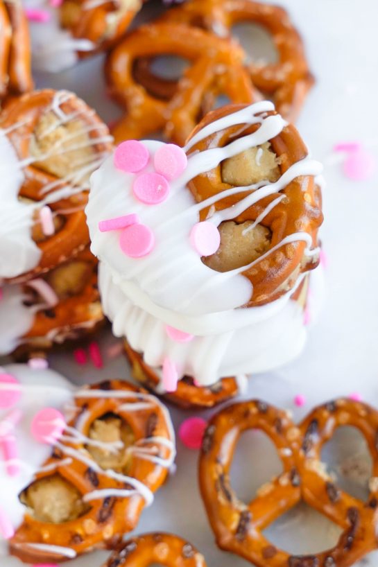 Valentine's Day Pretzel Bites recipe is so simple to make for any holiday, it's no wonder they're a classic! Two pretzels that are stuffed with a peanut butter filling and dipped in white chocolate coating. Great for gifts and parties!