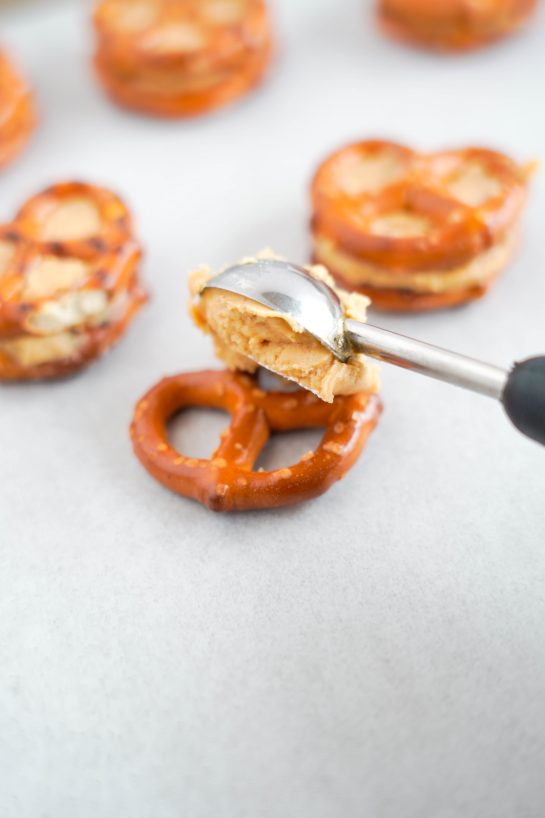 Scooping on the peanut butter to make the Valentine's Day Pretzel Bites recipe