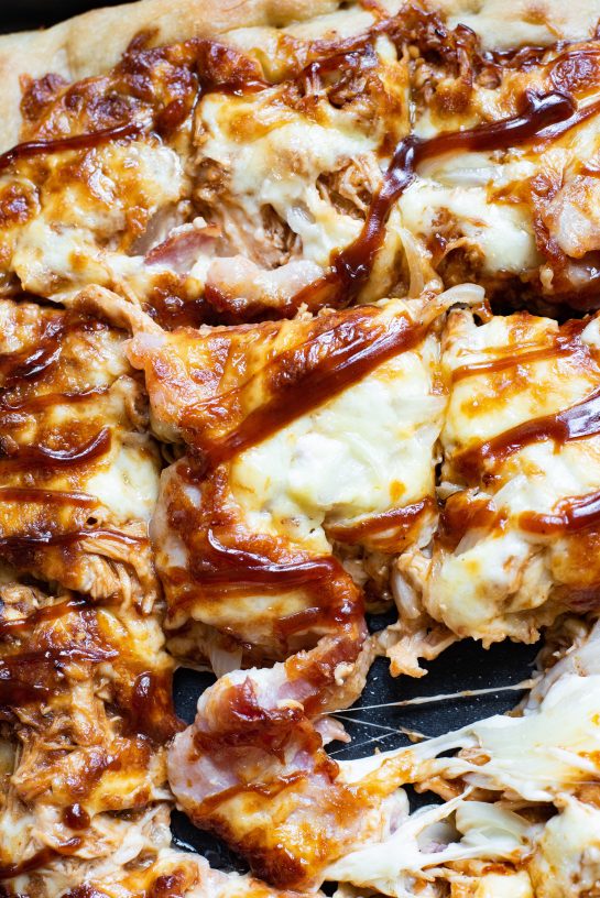 This recipe for Sheet Pan BBQ Chicken Pizza has a crispy crust, tons of cheese, and tender chicken, with the sweetness of hickory barbecue sauce. This pizza is the perfect balance of sweet, smoky, and savory goodness. It’s a snap to make!