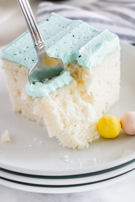 Easter Speckled Egg Snack Cake recipe is really easy to make for Easter dessert and it's so cute! You'll love the soft, baby blue for spring and the chocolate speckles created with a simple splatter of cocoa powder mixed with vanilla.