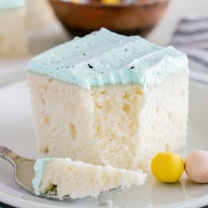 This Easter Speckled Egg Snack Cake recipe is really easy to make and it's so cute for Easter dessert! You'll love the soft blue for spring and the chocolate speckles created with a simple splatter of cocoa mixed with vanilla.