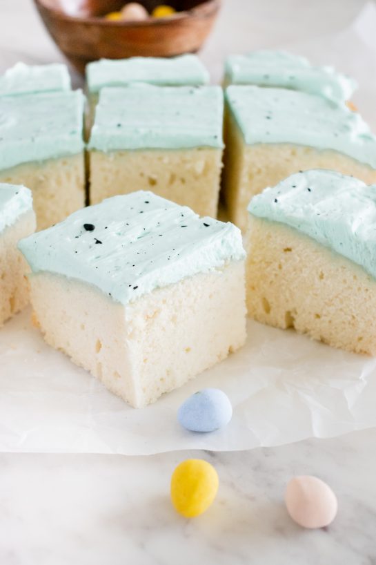 This Easter Speckled Egg Snack Cake recipe is really easy to make for Easter dessert and it's so cute for Easter dessert! You'll love the soft blue for spring and the chocolate speckles created with a simple splatter of cocoa mixed with vanilla.