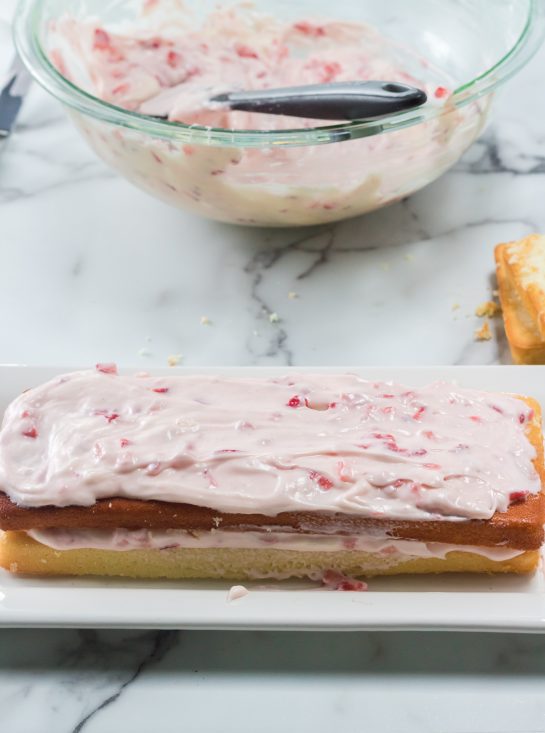 Frosting the Strawberries & Cream Layered Cake recipe for Easter