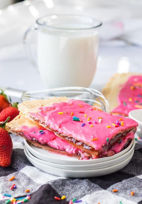 Easy Sheet Pan Strawberry Poptarts is a great dessert or breakfast recipe everyone will love. Pie Crust and strawberry jam give this dessert it's famous pop-tart flavor. These pop tarts are filled with REAL strawberry jam and topped with rainbow sprinkles. 