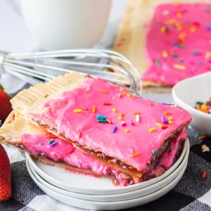 Sheet Pan Strawberry Poptarts is a great dessert recipe everyone will love. Pie Crust and strawberry jam give this dessert it's famous pop-tart flavor. These pop tarts are filled with REAL strawberry jam and topped with an sprinkles. 