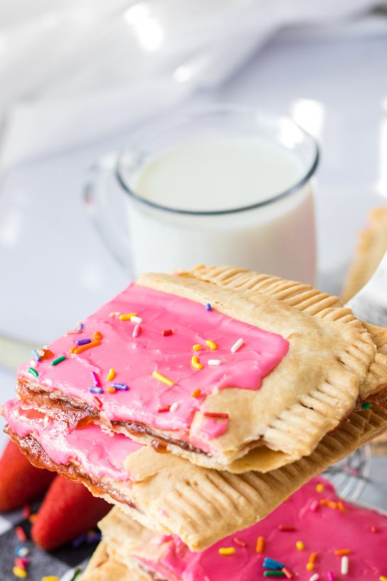 Sheet Pan Strawberry Poptarts is a great dessert recipe everyone will love. Pie Crust and strawberry jam give this dessert it's famous pop-tart flavor. These pop tarts are filled with REAL strawberry jam and topped with rainbow sprinkles. 