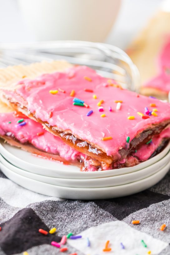 Sheet Pan Strawberry Poptarts is a great dessert recipe everyone will love. Pie Crust and strawberry jam give this dessert it's famous pop-tart flavor. These pop tarts are filled with REAL strawberry jam and topped with sprinkles. 