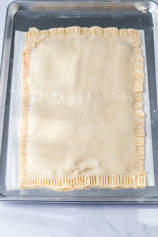 Crimping the dough for the sheet pan strawberry poptarts recipe