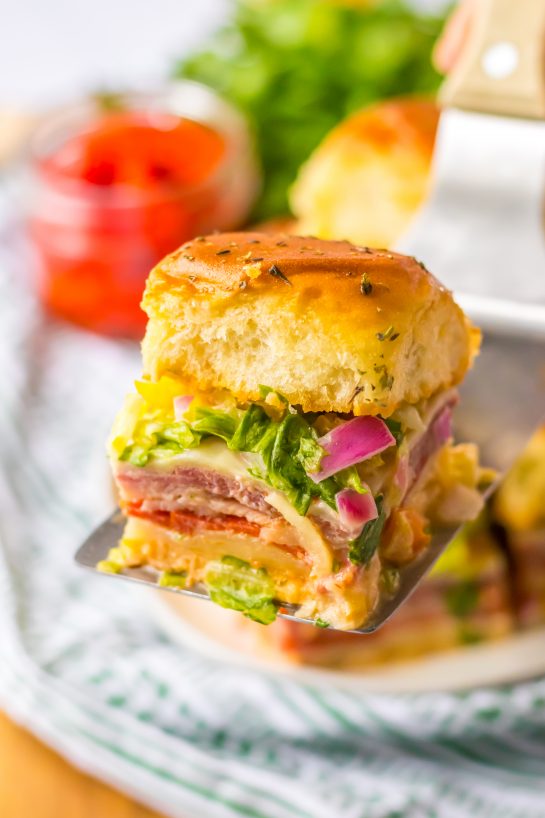 This Italian Sub Sliders recipe combines ham, salami, pepperoni and provolone, then gets baked until melty. Top them with your favorite toppings and mayo and you have a party crowd-pleaser!