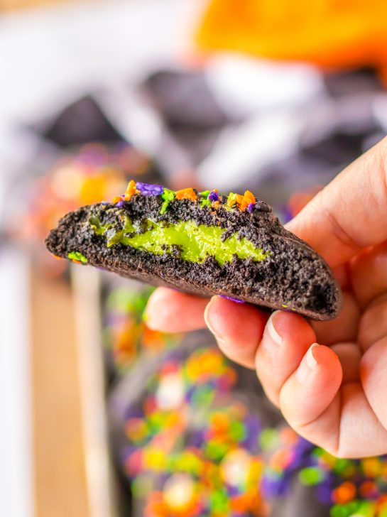Stuffed Black Velvet Cookies are perfect for Halloween dessert recipe.  Dark chocolate cookies are stuffed with a creamy, green cheesecake filling that is so delicious.  Halloween sprinkles top off these spooky cookies that everyone will love.