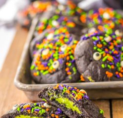 These Stuffed Black Velvet Cookies are perfect for a Halloween dessert recipe.  Dark chocolate cookies are stuffed with a creamy cheesecake filling that is so delicious.  Halloween sprinkles top off these spooky cookies that everyone will love at your party.