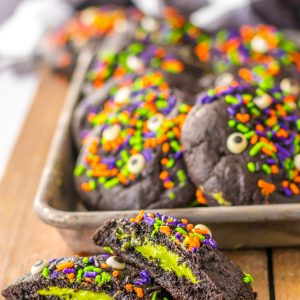 These Stuffed Black Velvet Cookies are perfect for a Halloween dessert recipe.  Dark chocolate cookies are stuffed with a creamy cheesecake filling that is so delicious.  Halloween sprinkles top off these spooky cookies that everyone will love at your party.