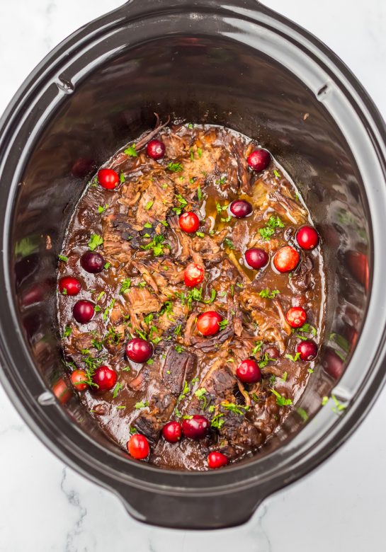 Crock Pot Cranberry Roast Beef is one of those easy, perfect slow cooker recipes to make for the holidays. Just a few ingredients are all you need to create this flavorful roast beef perfect for those chilly nights.  Onion soup mix and cranberry sauce come together to make a tasty gravy!