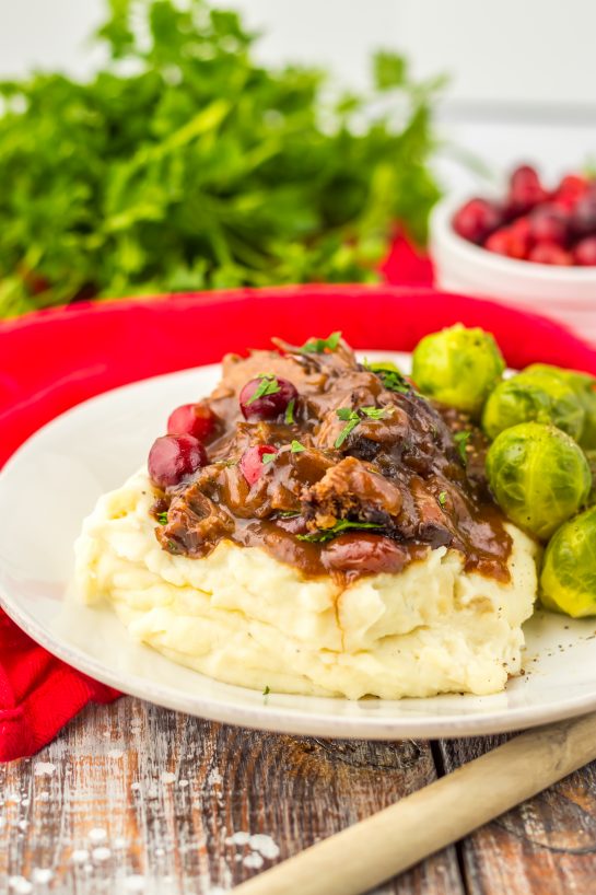 Crock Pot Cranberry Roast Beef is one of those easy, perfect slow cooker recipes to make for the holidays. Just a few ingredients are all you need to create this flavorful roast beef perfect for those chilly nights.  Onion soup mix and cranberry sauce come together to make a delicious gravy!
