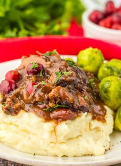Crock Pot Cranberry Roast Beef is one of those easy, perfect slow cooker recipes to make for the holidays. Just a few ingredients are all you need to create this flavorful roast beef perfect for those chilly nights.  Onion soup mix and cranberry sauce come together to make a delicious gravy!