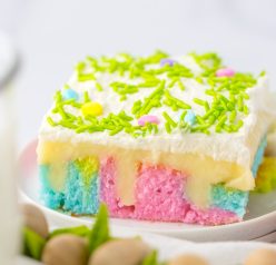 Easter Poke Cake is the prettiest, tastiest dessert for spring! This was such an easy and super fun cake to make! It’s the perfect sweet treat for Easter! Cake mix, white chocolate pudding layer and an amazing whipped cream spread on top! 