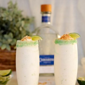 Coconut Lime Frozen Margaritas are a smooth, creamy, and easy to make frozen drink recipe!  Almost as easy as they are to sip on!  Creamy coconut blends with tequila and fresh lime topped with a crunchy toasted coconut rim.