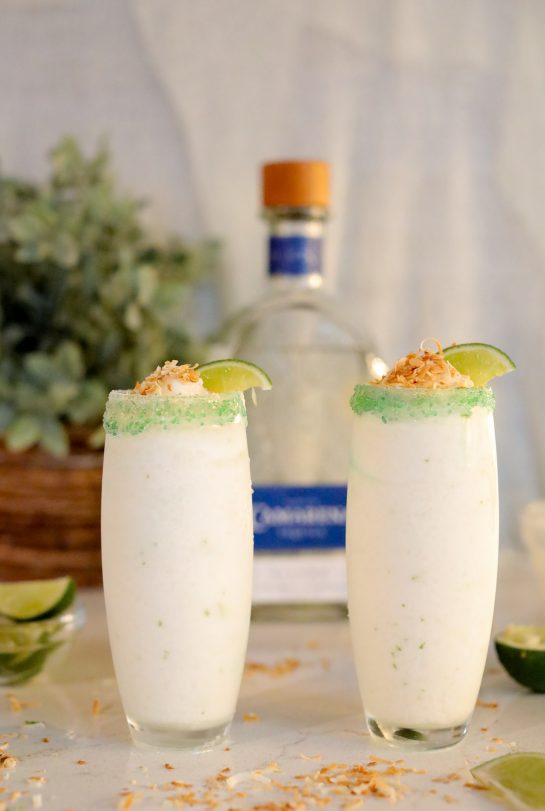 Coconut Lime Frozen Margaritas are a smooth, creamy, and easy to make frozen drink recipe!  Almost as easy as they are to sip on!  Creamy coconut blends with tequila and fresh lime topped with a crunchy toasted coconut rim.