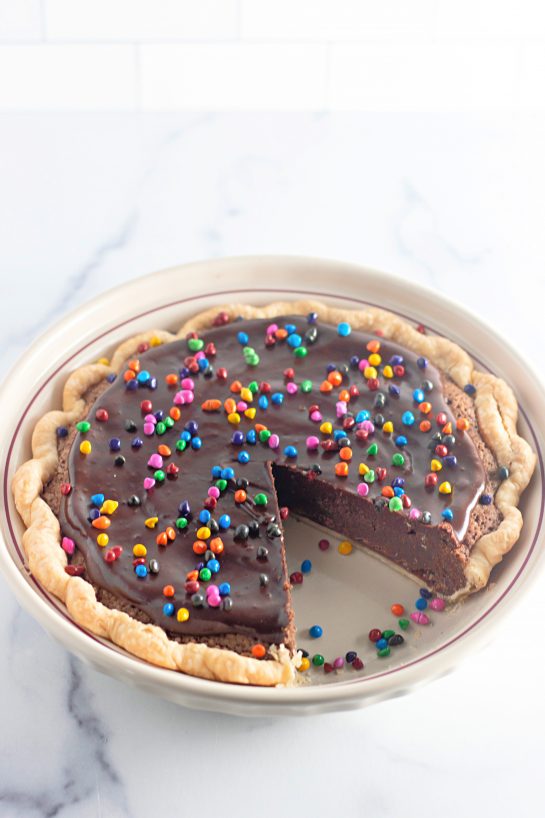 Cosmic Brownie Pie recipe is a small slice chocolate heaven in a recipe. This photo shows a slice taken out of the pie.