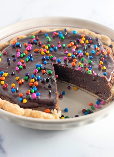 Easy Cosmic Brownie Pie recipe is a small slice of chocolate heaven in a recipe. This photo shows a slice taken out of the pie.