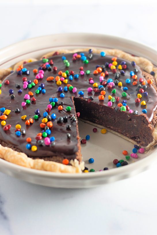 Easy Cosmic Brownie Pie recipe is a small slice chocolate heaven in a recipe. This photo shows a slice taken out of the pie.
