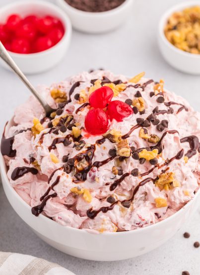 Banana Split Fluff Salad is a quick and easy recipe that turns a classic ice cream treat into a deliciously creamy “dump and go” dessert salad or side dish!