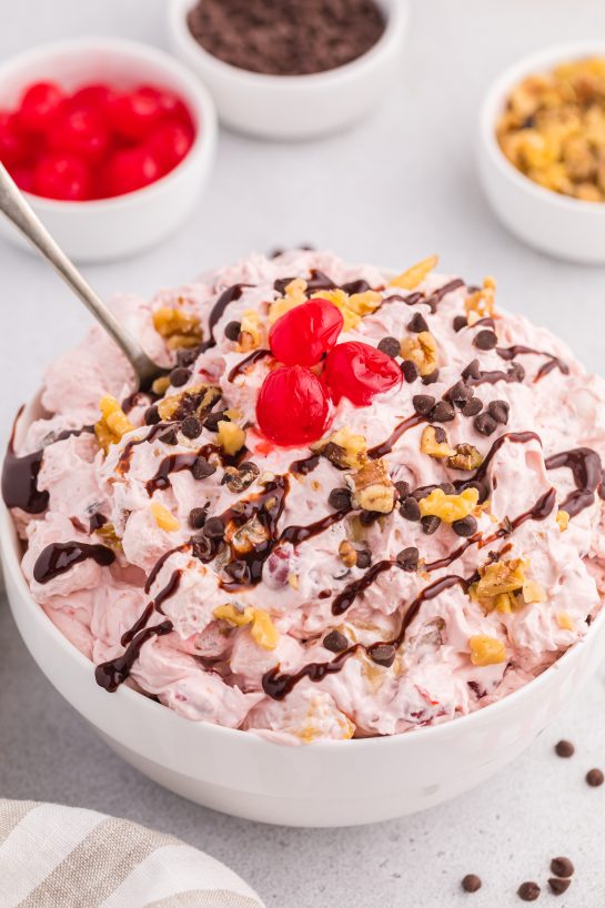 Banana Split Fluff Salad is a quick and easy recipe that turns a classic ice cream treat into a deliciously creamy “dump and go” dessert salad or side dish!