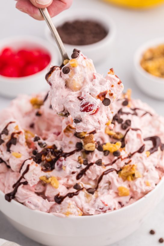 Banana Split Fluff Salad is a quick and easy recipe that turns a classic ice cream treat into a deliciously creamy “dump and go” dessert salad or side dish for a picnic!