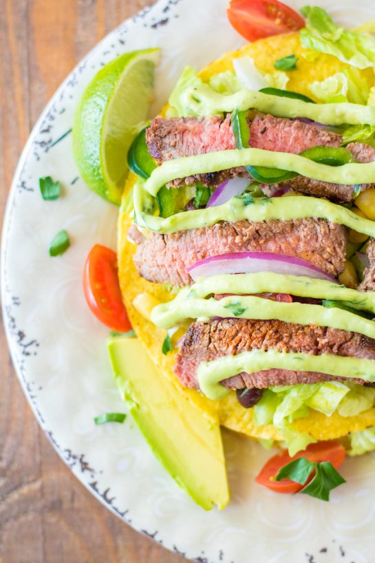 Easy Steak Tostada Salad recipe has a Mexican twist and is the steak salad of your dreams! It's loaded with a juicy steak, your favorite veggies, and a creamy cilantro-lime vinaigrette. It makes a delicious healthy lunch or dinner salad!