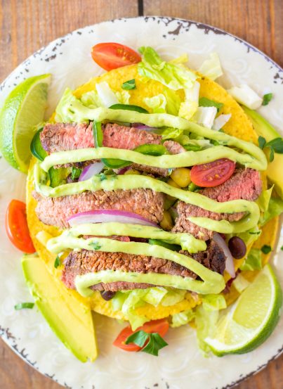 Steak Tostada Salad recipe has a Mexican twist and is the steak salad of your dreams! It's loaded with a juicy steak, your favorite veggies, and a creamy cilantro-lime vinaigrette. It makes a delicious healthy lunch or dinner salad!