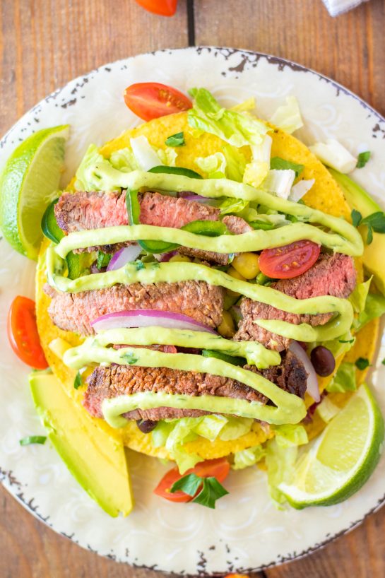 Steak Tostada Salad recipe has a Mexican twist and is the steak salad of your dreams! It's loaded with a juicy steak, your favorite veggies, and a creamy cilantro-lime vinaigrette. It makes a delicious healthy lunch or dinner salad!