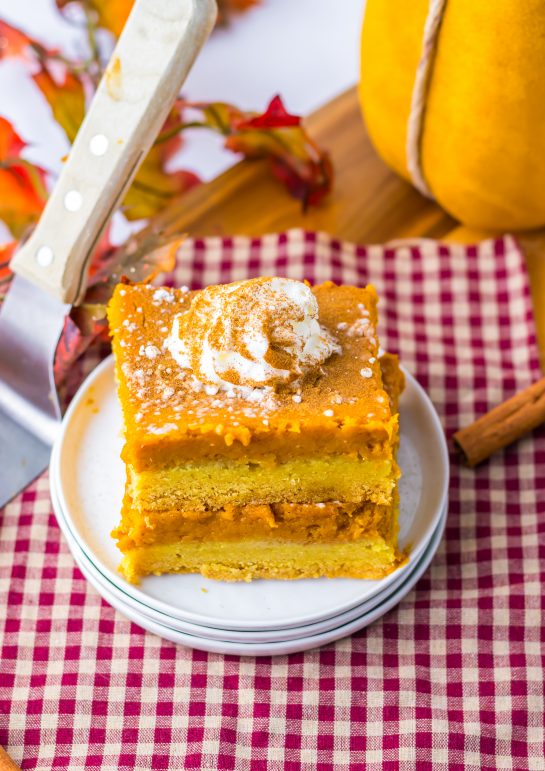 Easy Pumpkin Gooey Butter Cake recipe is always a classic and I swear it is better than pumpkin pie.  It is even better than pumpkin pie and always a favorite in Fall and around the holidays.  A simple crust made from a yellow cake mix get topped with the most luscious pumpkin filling of pumpkin, butter, cream cheese and powdered sugar. A sprinkle of powdered sugar and a dollop of whipped cream makes this cake a showstopper.