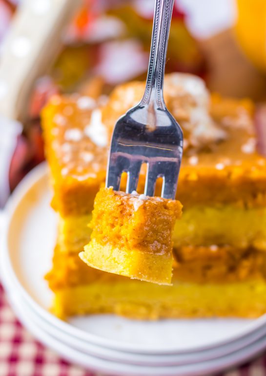 Pumpkin Gooey Butter Cake recipe baked sliced and close-up of a piece of it on the fork.