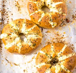 These Tik Tok Stuffed Bagels are going viral and there is a good reason! Bagels are sliced and stuffed with a sweetened cream cheese. They are brushed with a garlic butter and sprinkled with parmesan cheese before getting baked in the oven.  These totally take bagels to a whole new level.  This includes the directions for the air fryer, as well.