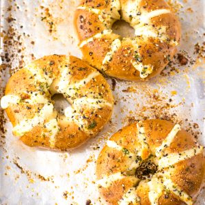 These Tik Tok Stuffed Bagels are going viral and there is a good reason! Bagels are sliced and stuffed with a sweetened cream cheese. They are brushed with a garlic butter and sprinkled with parmesan cheese before getting baked in the oven.  These totally take bagels to a whole new level.  This includes the directions for the air fryer, as well.